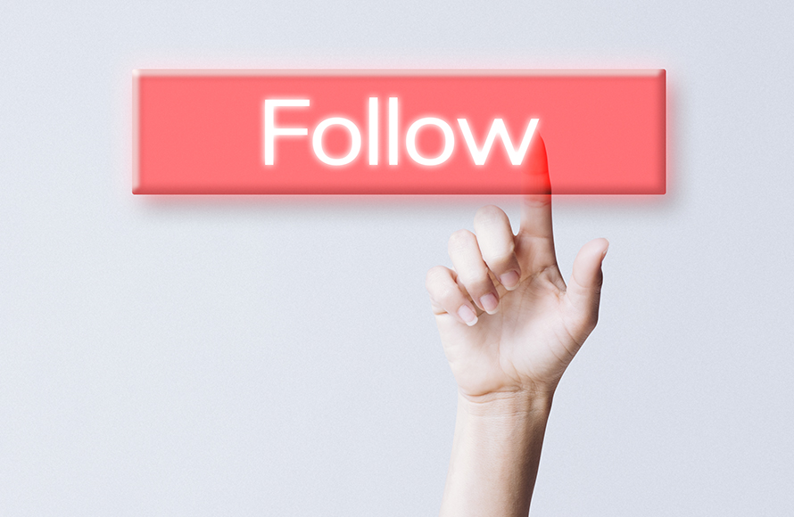 Hand clicking follow button on social media