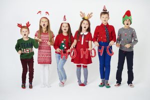 Happy children singing christmassy carols